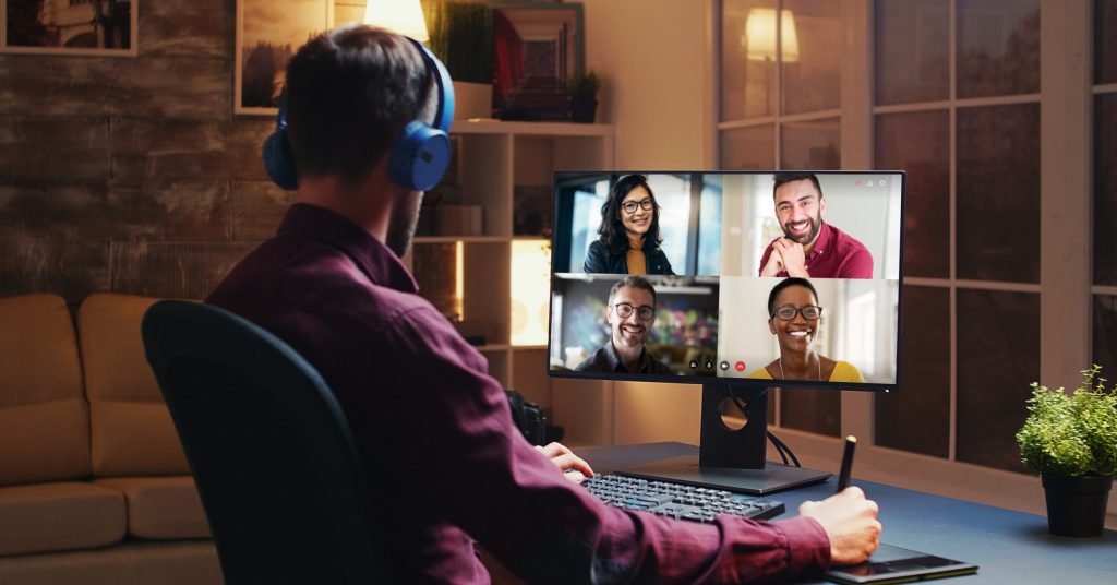 Man videoconferencing with four colleagues from home